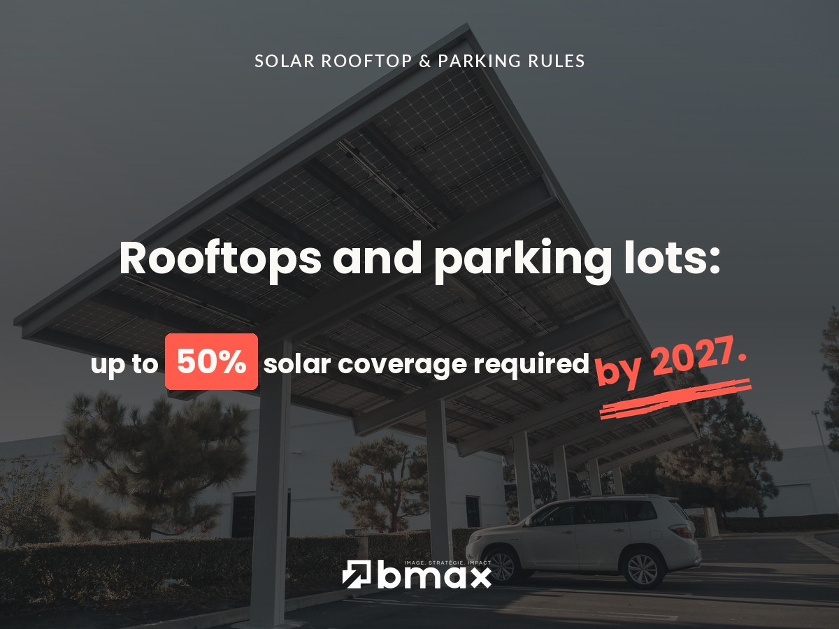 Solar carport above a company parking lot with a car parked underneath, illustrating the French solar rooftop and parking obligation.